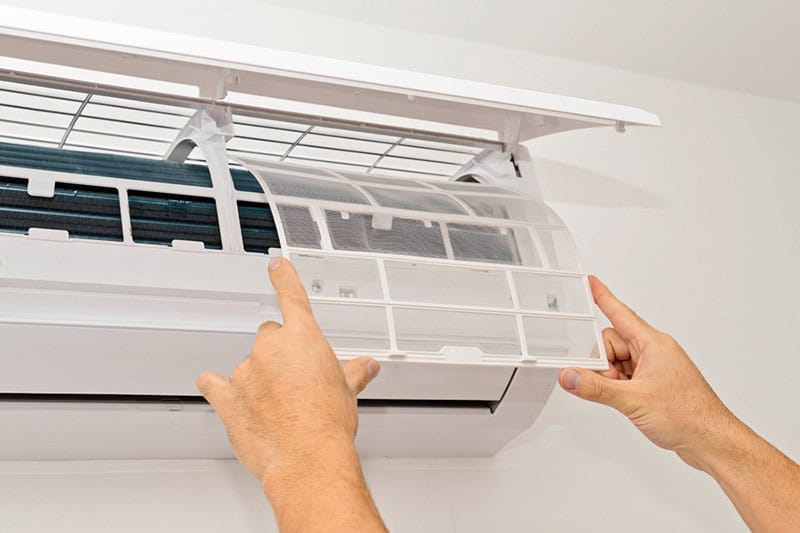 Man fixing a ductless unit