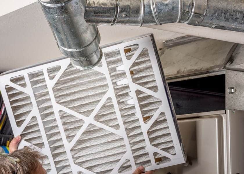 What Are Furnace Filters? Image shows a furnace filter being changed.