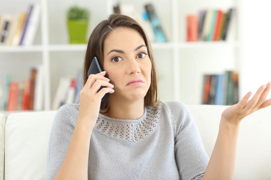 woman on phone with HVAC company asking if you really need an AC tune-up.