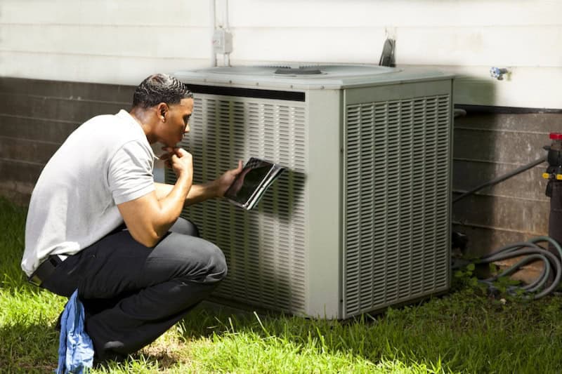 5 Common AC Problems. Tech opening HVAC unit.